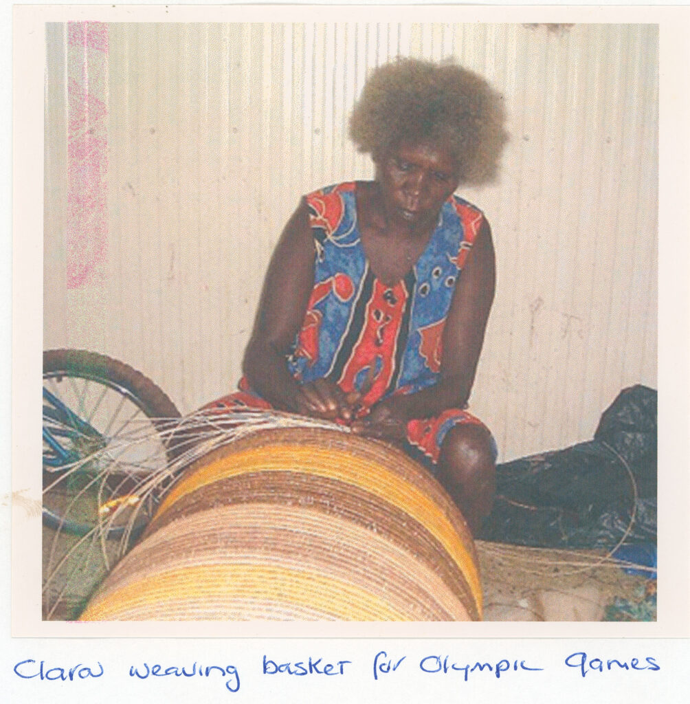 Clara Wubukwubuk weaving a basket for the Olympic Games.
